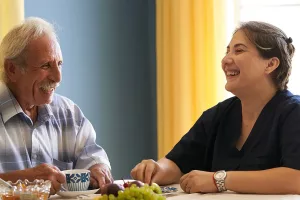 Family Caregiver enjoying meal with his loved one
