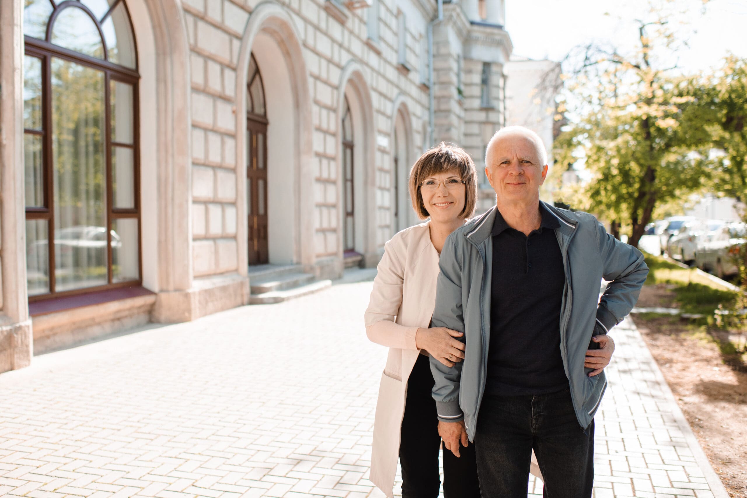 Senior happy couple of stylish man and woman 60-65 year old walking together on streets at city outdoors. Wellness lifestyle. Happiness. Take Control of Pain: A Veteran and Caregiver Perspective